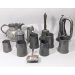 A 19th century pewter jug four pint capacity, a Victorian brass hand bell with turned wood handle,