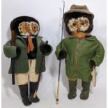 A pair of character soft toy standing figures with feathery owl faces, both dressed for country