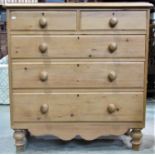 A Victorian stripped pine bedroom chest of two short over three long graduated drawers with shaped