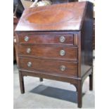 An Edwardian mahogany writing bureau in the Georgian style, the fall flap with applied split bead