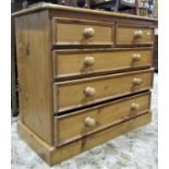A stripped pine bedroom chest of two short over three long graduated and moulded drawers set on a