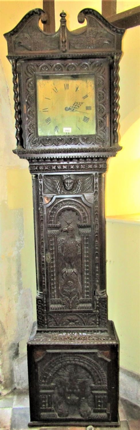 A 19th century oak longcase clock, the case profusely carved depicting a lion, eagle, cherubs,