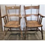 Two similar 19th century elm and beechwood kitchen armchairs with curved bar splats over saddle