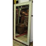 A large painted pine framed wall mirror of rectangular form with bevelled edge plate within a