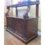 A late Regency period buffet, the lower section enclosed by two panelled doors, with pronounced