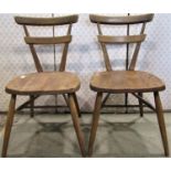 A pair of vintage Ercol elm and beechwood low stacking, possibly school, chairs with tapered and