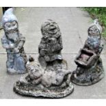 Four small reclaimed garden gnomes in various poses, weathered with traces of original painted