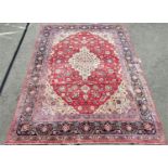 Good quality large Kashan carpet with typical floral pattern with blue running borders upon a red