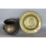 A bronze cauldron with loop handle and a further embossed brass dish with hammered and stamped