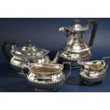 Early 20th century Georgian style boat shaped half fluted four piece tea service comprising