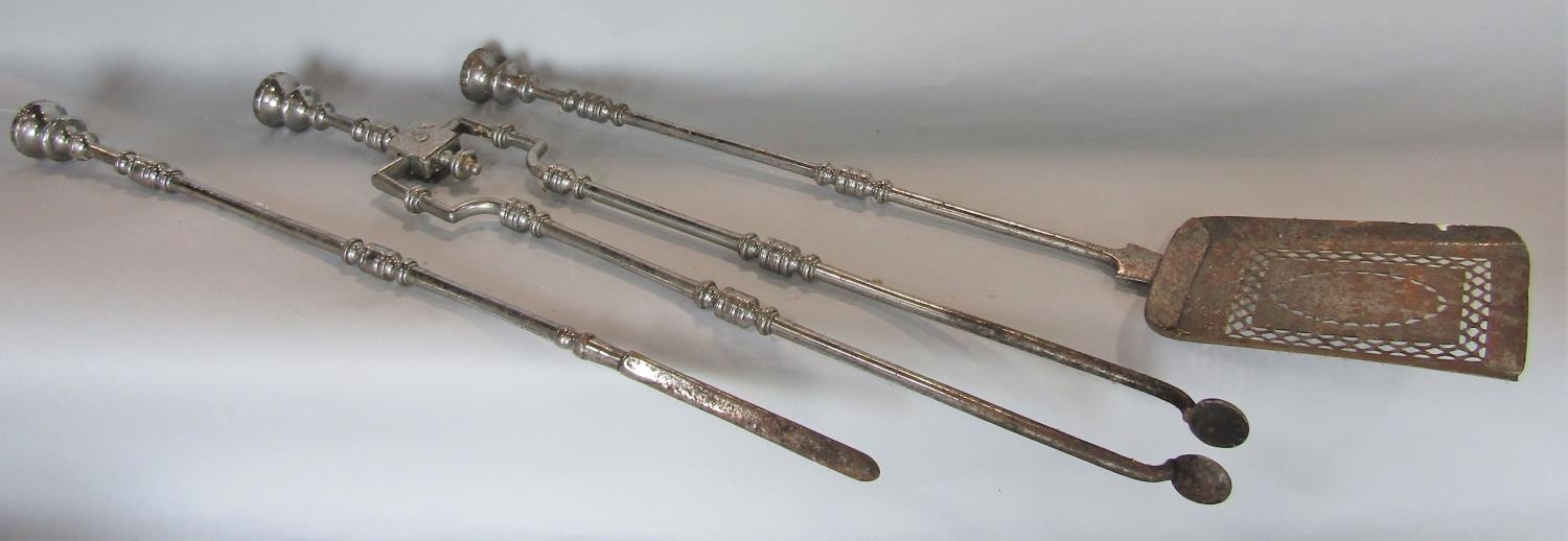 A set of three 19th century polished steel fire irons, poker tongs and shovel