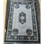 Chinese full pile wool and silk rug with central bottle green medallion with further green borders