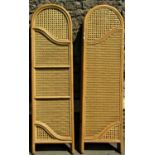 A pair of floorstanding three fold split cane and wicker screens with arched panels 160 cm high