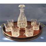 A decanter and tumbler set within a twin handled mahogany tray, the tray 48 cm long, together with a