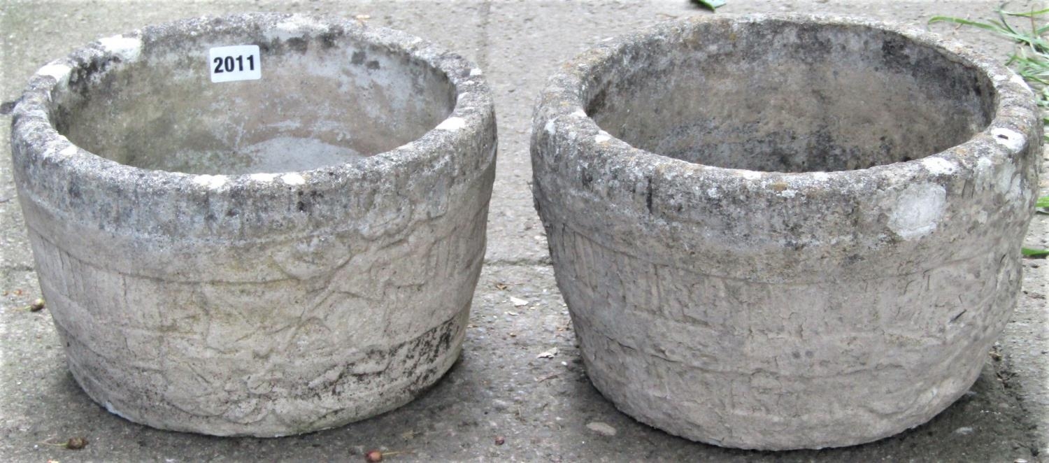 A pair of small reclaimed garden planters in the form of coopered half barrels with trailing ivy