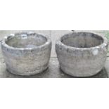 A pair of small reclaimed garden planters in the form of coopered half barrels with trailing ivy