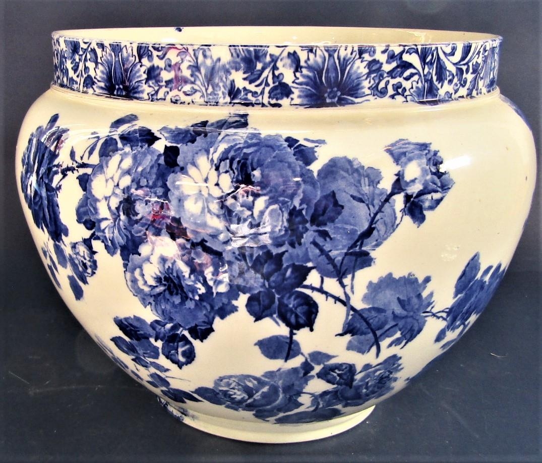 A large Doulton Burslem Gloire-de-Dijon patterned jardinière with blue printed floral decoration,
