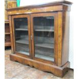 A Victorian walnut and floral marquetry inlaid pier cabinet enclosed by two arched panelled doors,