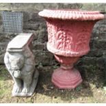 A reclaimed two sectional garden urn with flared rim and repeating foliate detail, raised on a