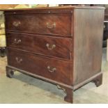 A Georgian mahogany chest with brushing slide over three long graduated drawers with brass swan neck