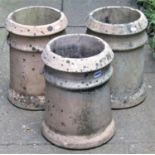 Three reclaimed buff coloured chimney pots of squat cylindrical form, 38cm high