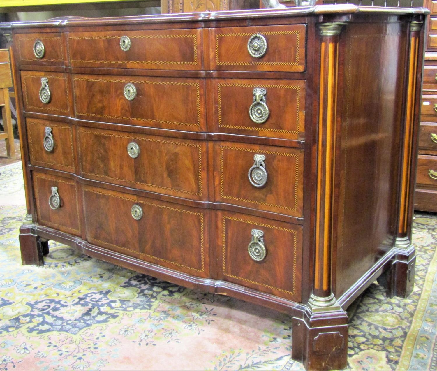 An 18th century Dutch commode of four long graduated drawers, with shaped front within fluted column