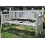 An arts and crafts style garden bench with slatted framework, painted finish and shaped finials (af)