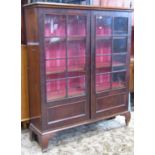 A 19th century mahogany side cabinet, freestanding and enclosed by a pair of partially glazed and