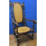 A 17th century and later Carolean elbow chair in walnut, with turned supports, cane panelled seat