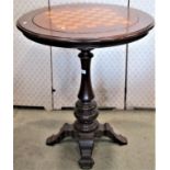 A Victorian style games table of circular form with inset revolving and reversible chequer board,