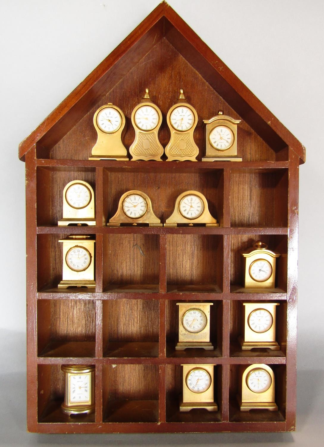 A collection of fourteen miniature brass cased mantel clocks of varying design by Park Lane,