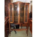 An inlaid Edwardian mahogany china display cabinet, the two central doors of bow fronted raised on