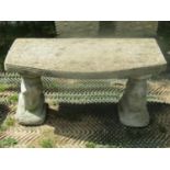 A pair of reclaimed three sectional garden benches with bow fronted slab seats and repeating