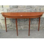 A mid 20th century hardwood demi lune hall/side table raised on four turned tapered supports 132cm x