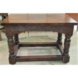An old English style oak refectory table with rectangular top over a carved frieze and four heavy