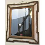 An antique wall mirror with rectangular bevelled edge plate within a gilt and moulded frame with