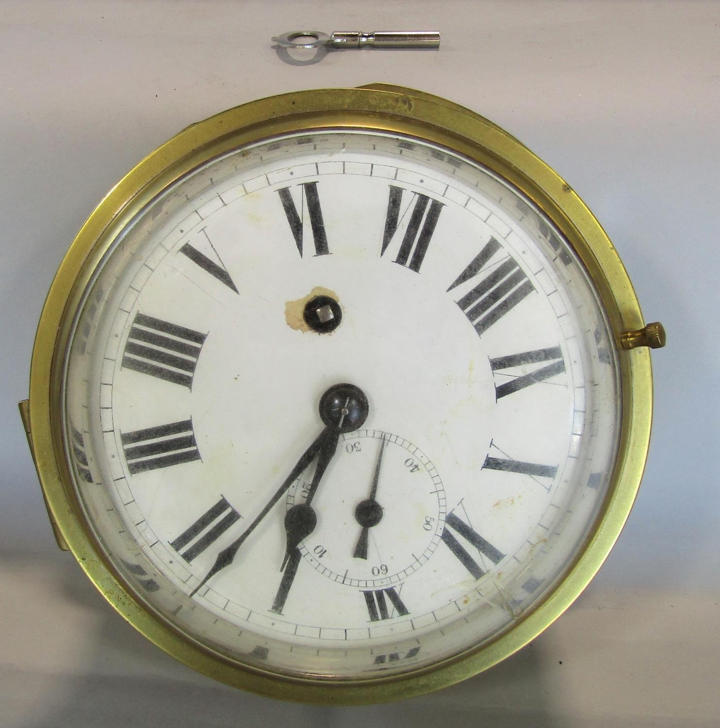 An eight day English bulkhead clock with brass casework, with fusee and chain and lever escapement