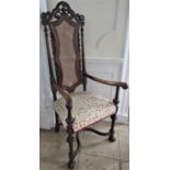 Carolean style elbow chair in walnut with well carved detail, scrolled arms, X shaped stretcher