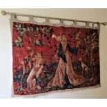 Wall hanging depicting a printed medieval scend of a woman with a falcon, hunting dog and lion in an