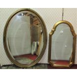 A shield shaped wall mirror with moulded gilt frame 76 cm x 43 cm, together with a further oval gilt