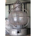 A vintage paraffin storm lantern, with globular glass encased shade