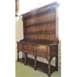 A good quality antique style oak dresser with two tier open plate rack with boarded back over