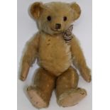 1930's teddy bear possibly by Merrythought with golden mohair, slight humped back, glass eyes,