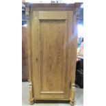 A 19th century European stripped pine wardrobe/side cupboard enclosed by a full length rectangular