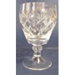 A thistle cut glass lidded decanter together with a further decanter and various goblets