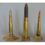 Trench art interest - three bullet cigarette lighters on stepped bases, 18cm and smaller