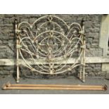 A Victorian style tubular steel framed double bedstead with arched and scrolled rails, with