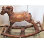 A carved hardwood rocking horse with cradle rocker