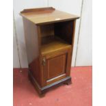 An inlaid Edwardian mahogany bedside cupboard, the lower section enclosed by a panelled door, with