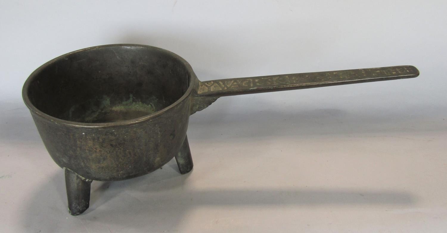 An 18th century bell metal skillet, the handle with script 'Ye Wages Of Sin Is Death'